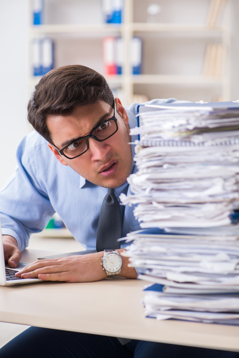 Extremely Busy Businessman Working in Office